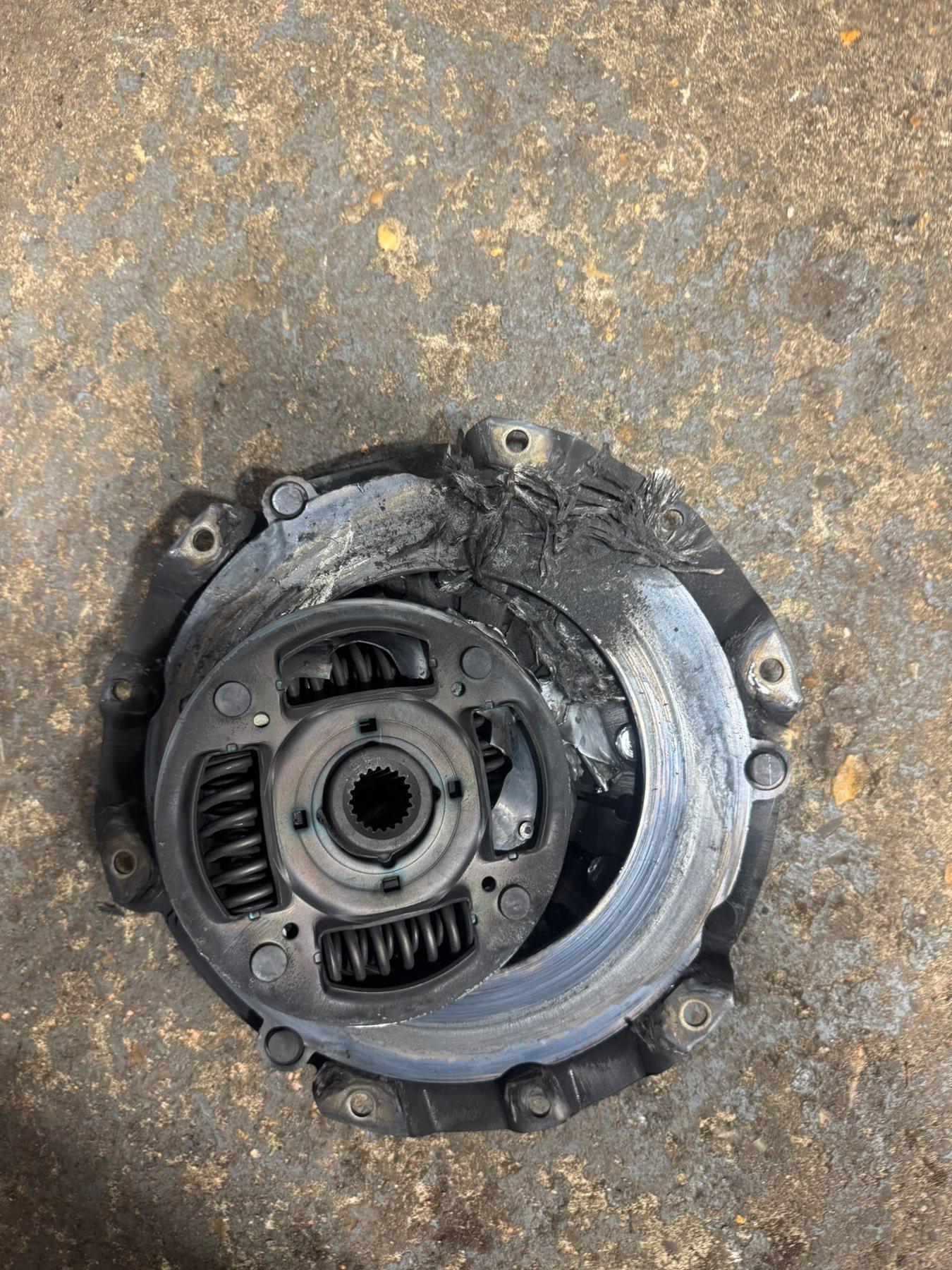Removed clutch disc and pressure plate on the garage floor