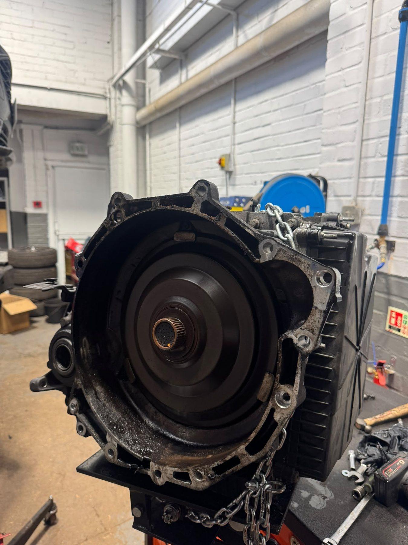 Removed transmission housing standing upright in the garage