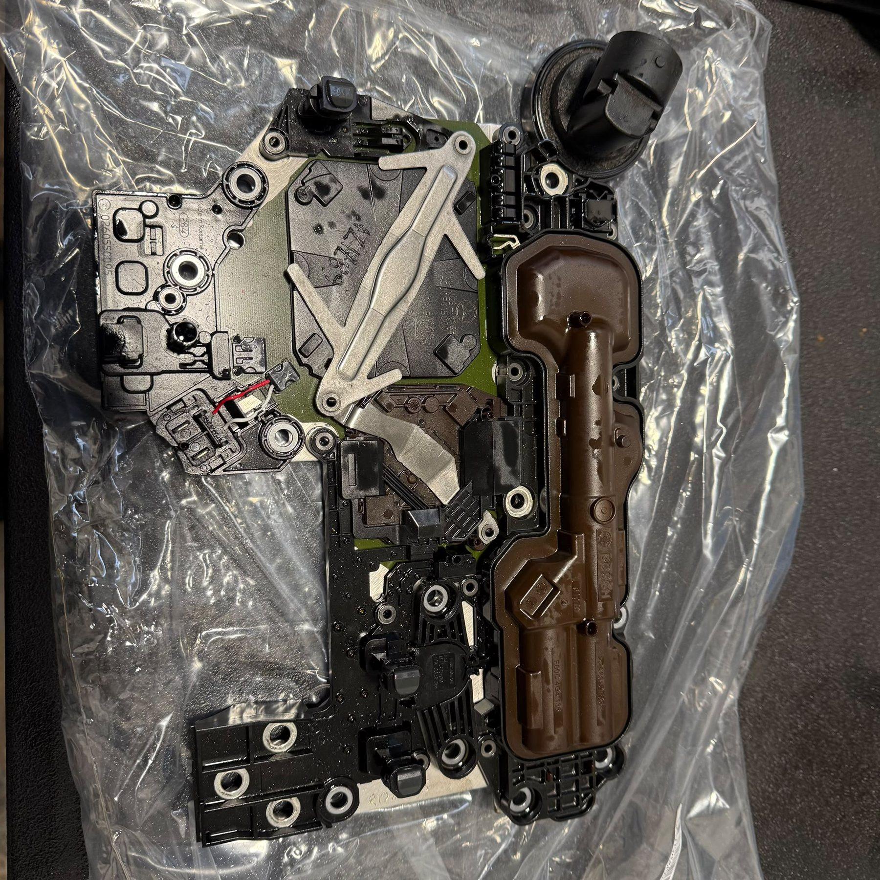 Transmission control assembly opened to show its channels and internal components