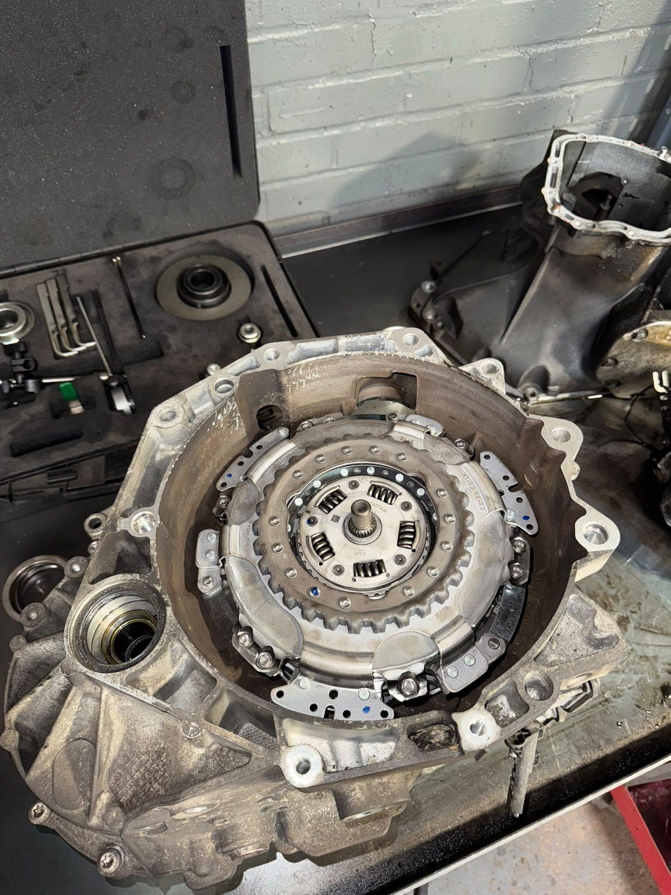 Close view of a clutch and flywheel assembly during garage repair